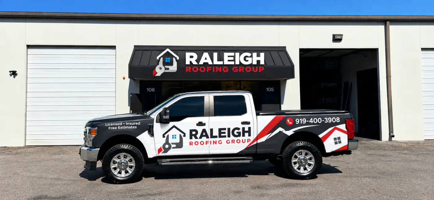 Raleigh Roofing Group branded work truck parked outside the company storefront